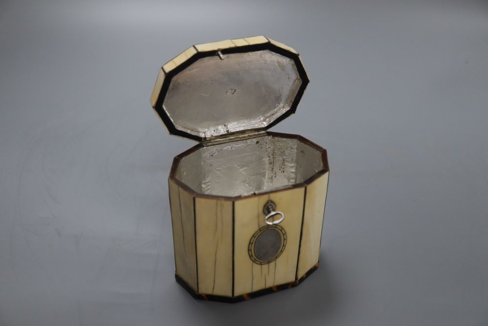 A George III decagonal ivory and tortoiseshell veneered tea caddy, height 10cm